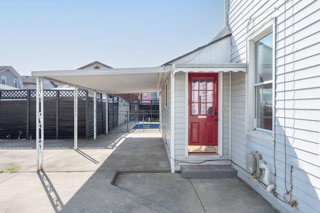 view of exterior entry with a carport