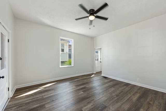 unfurnished room featuring a textured ceiling, dark hardwood / wood-style floors, and ceiling fan