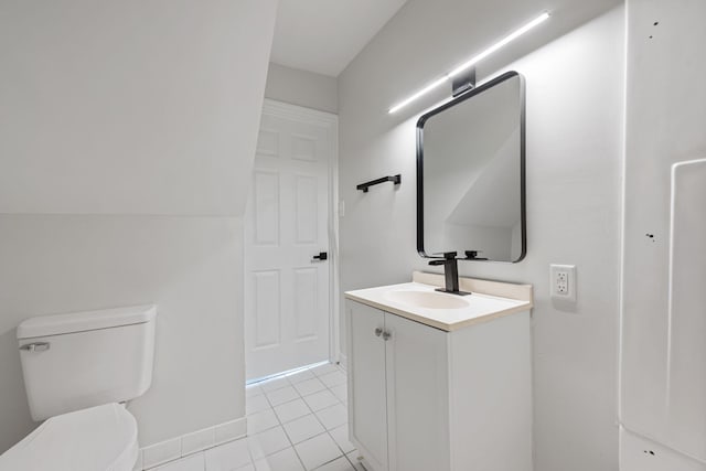 bathroom with tile patterned flooring, vanity, and toilet