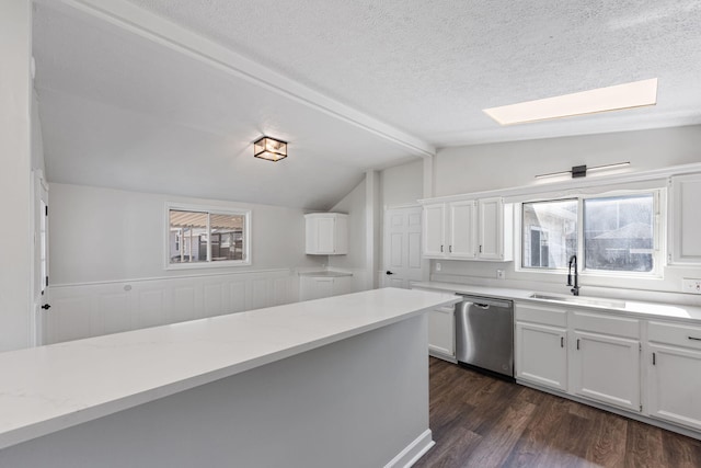 kitchen featuring a textured ceiling, dishwasher, white cabinetry, and sink