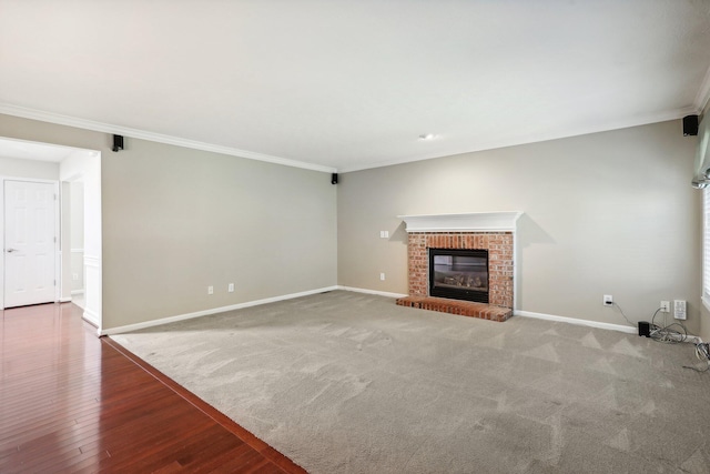 unfurnished living room with carpet, crown molding, and a fireplace