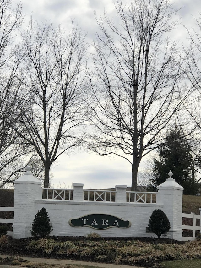 community sign featuring fence