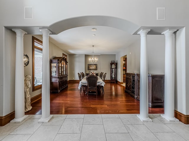 dining area featuring light hardwood / wood-style floors and a notable chandelier