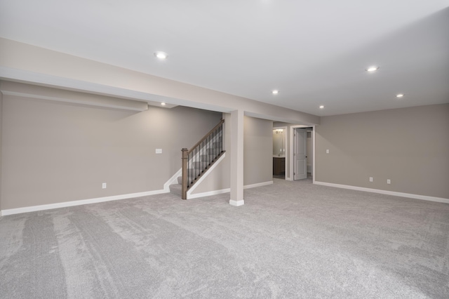 basement featuring light carpet