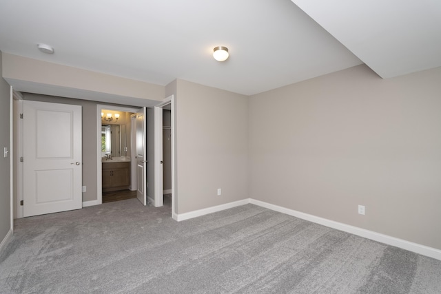 unfurnished bedroom featuring carpet and ensuite bath