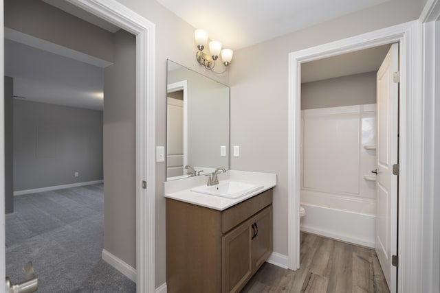 full bathroom featuring vanity, wood-type flooring, shower / bathtub combination, and toilet