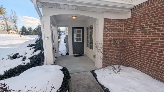 view of snow covered property entrance