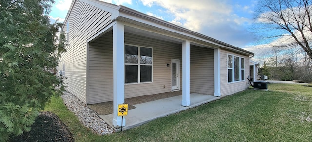 view of property exterior with a lawn and central AC unit