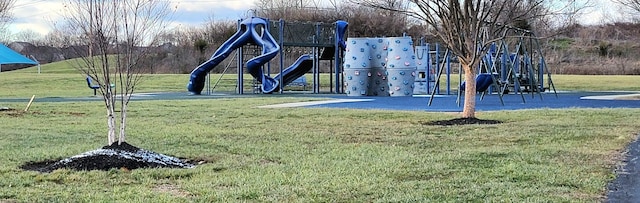 view of home's community with a playground and a lawn