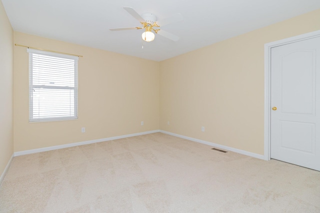 unfurnished room featuring ceiling fan and light carpet