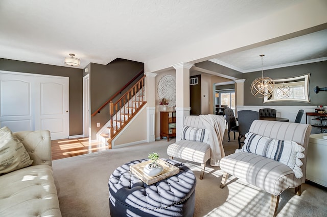 living room featuring light carpet, an inviting chandelier, ornate columns, and crown molding