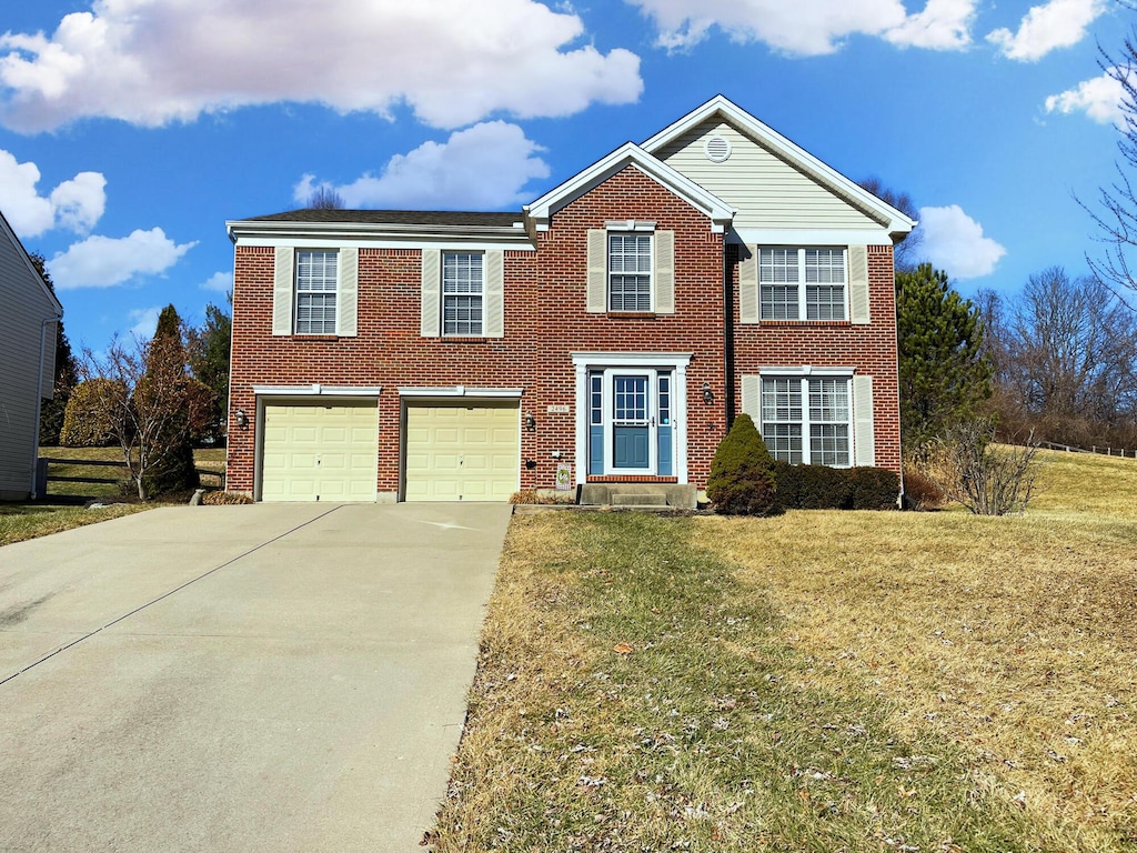 view of front of property featuring a garage and a front yard