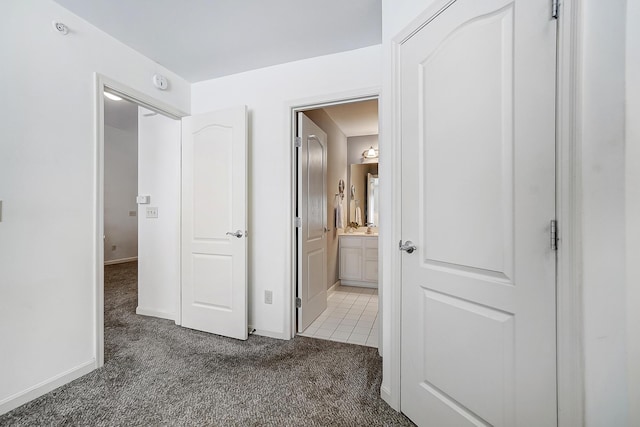 corridor with dark colored carpet