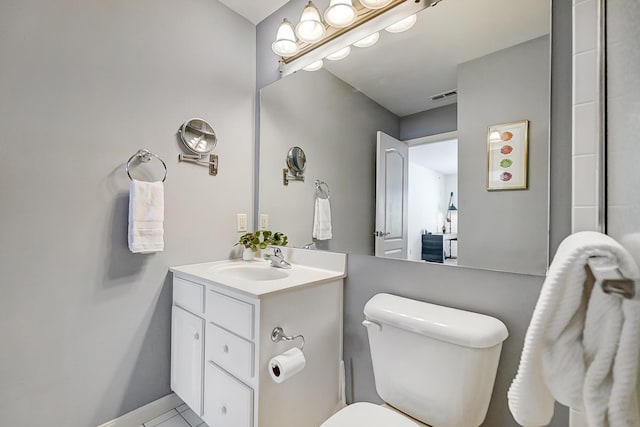 bathroom featuring tile patterned floors, vanity, and toilet