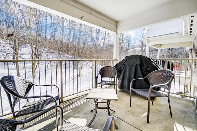 view of snow covered back of property