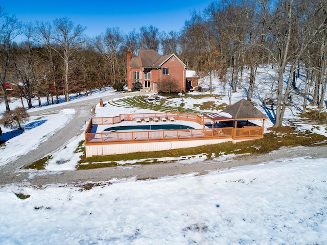 snow covered house with a gazebo