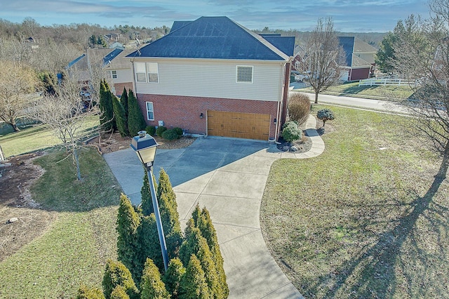 view of side of property with a garage and a yard