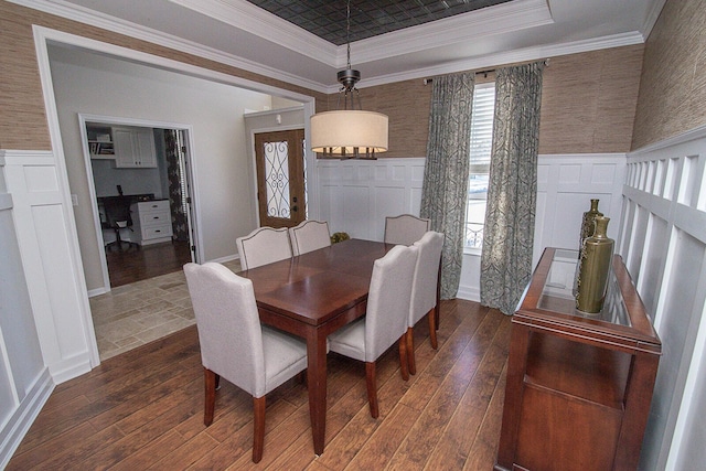 dining space with dark wood-type flooring and ornamental molding