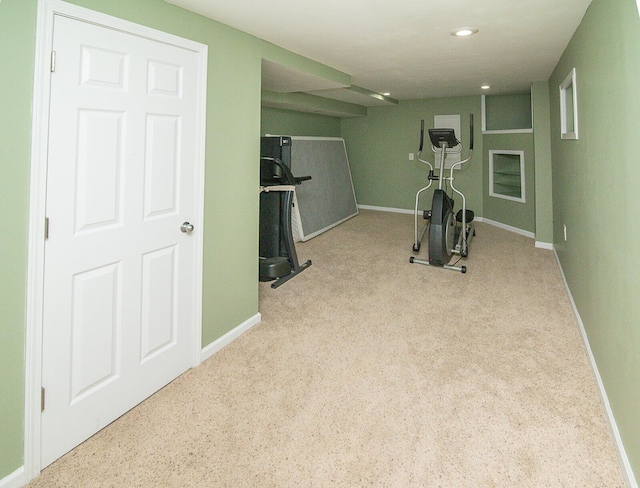 workout area featuring light carpet