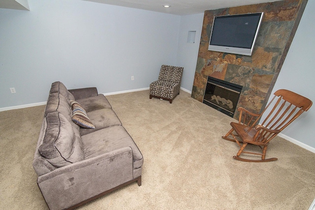 carpeted living room featuring a fireplace