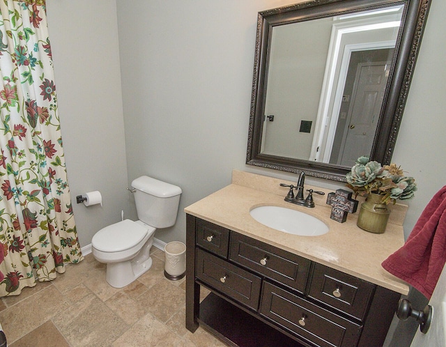 bathroom featuring toilet and vanity