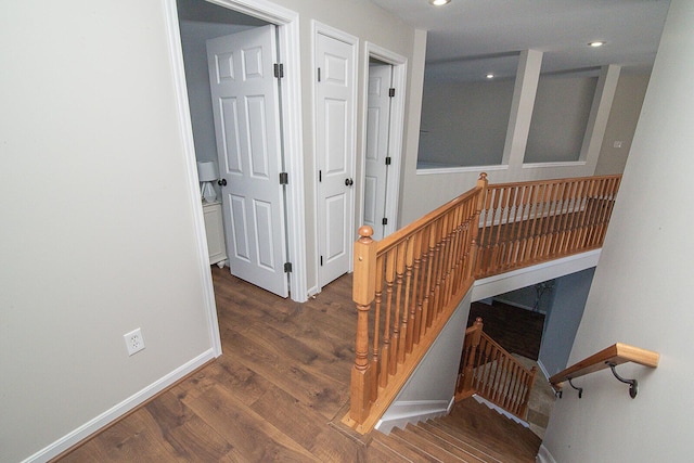 staircase with hardwood / wood-style flooring