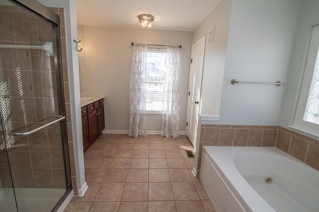 bathroom with tile patterned flooring, shower with separate bathtub, and vanity