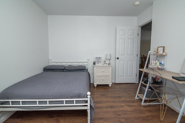 bedroom with dark hardwood / wood-style flooring