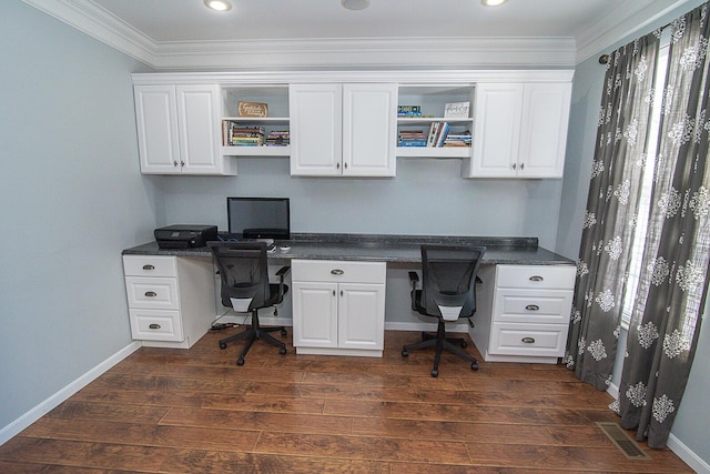 office area featuring dark hardwood / wood-style floors, crown molding, and built in desk