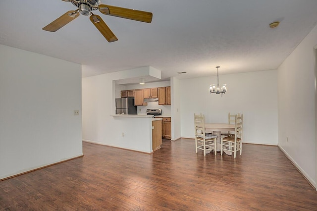 living room featuring ceiling fan with notable chandelier and dark wood-type flooring