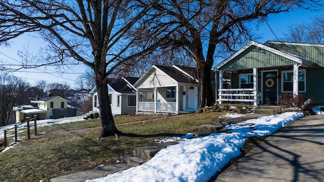 bungalow-style home with a yard and a porch