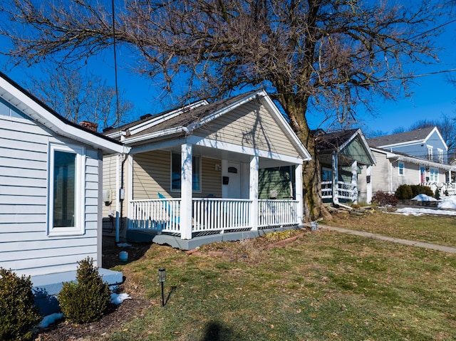 view of front of home featuring a front yard and covered porch