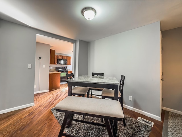 dining room featuring hardwood / wood-style flooring