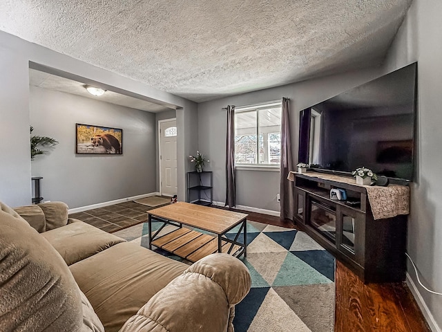 living room with dark wood-type flooring and a textured ceiling