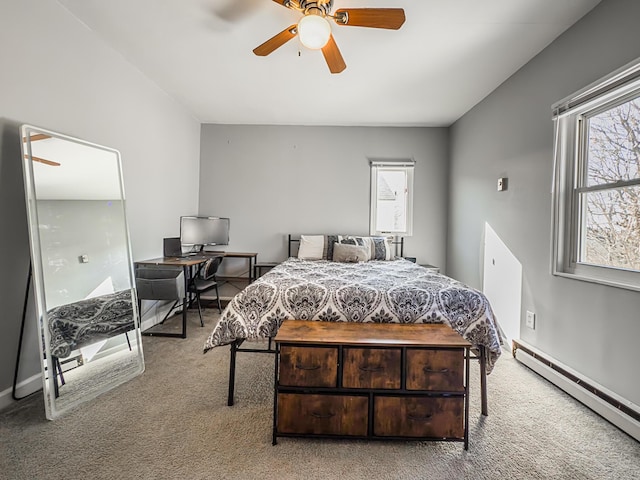 bedroom featuring multiple windows, ceiling fan, light carpet, and baseboard heating