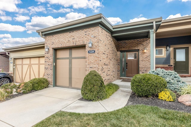 doorway to property with a garage