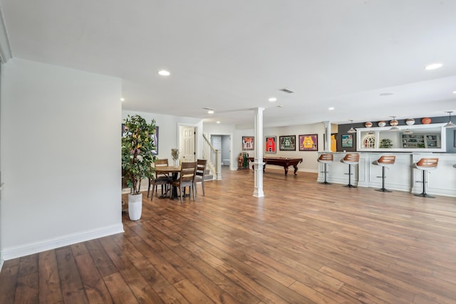 interior space with bar, wood-type flooring, and billiards