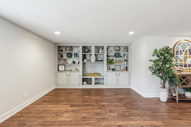 bar featuring built in features and dark hardwood / wood-style flooring