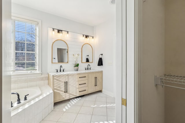 bathroom with vanity, plenty of natural light, tile patterned floors, and tiled tub