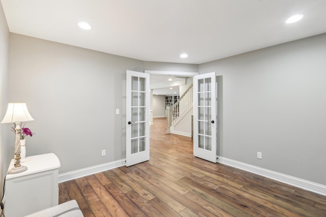 unfurnished room featuring hardwood / wood-style floors and french doors