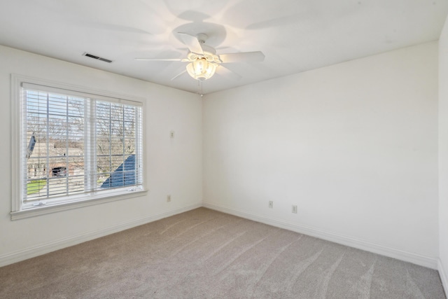 empty room with ceiling fan and carpet