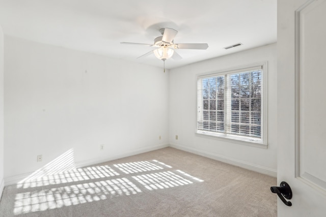 carpeted spare room featuring ceiling fan