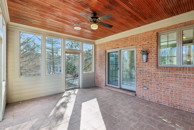 unfurnished sunroom with ceiling fan and wood ceiling