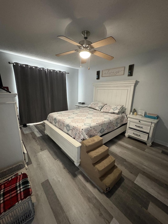 bedroom featuring dark hardwood / wood-style flooring and ceiling fan