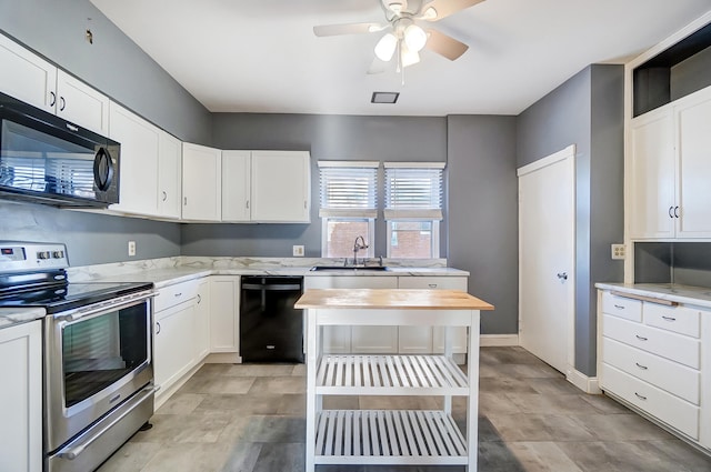 kitchen with sink, white cabinetry, ceiling fan, light stone countertops, and black appliances