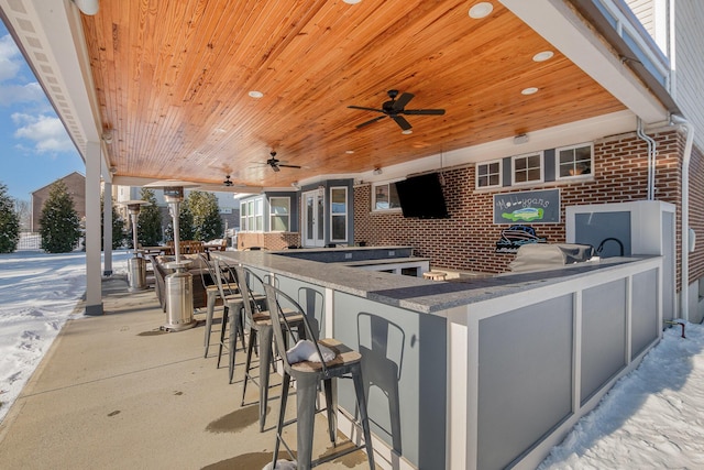 view of patio / terrace with an outdoor bar and ceiling fan