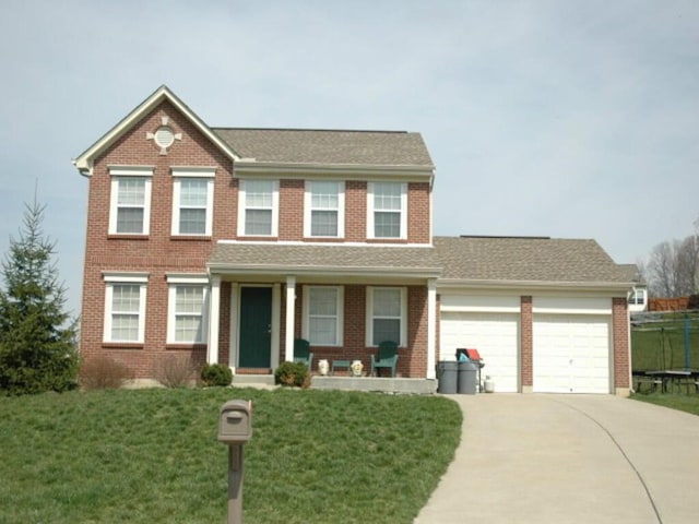 view of front facade with a front lawn and a garage