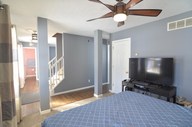 bedroom with ceiling fan and light colored carpet