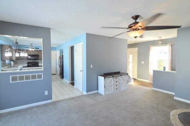 unfurnished living room with light colored carpet, a textured ceiling, and sink