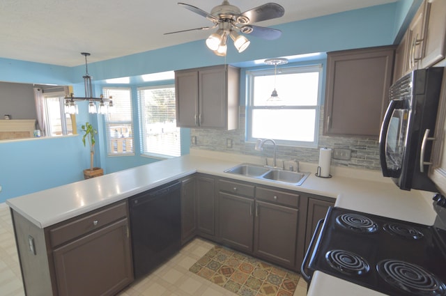 kitchen featuring black appliances, hanging light fixtures, kitchen peninsula, decorative backsplash, and sink